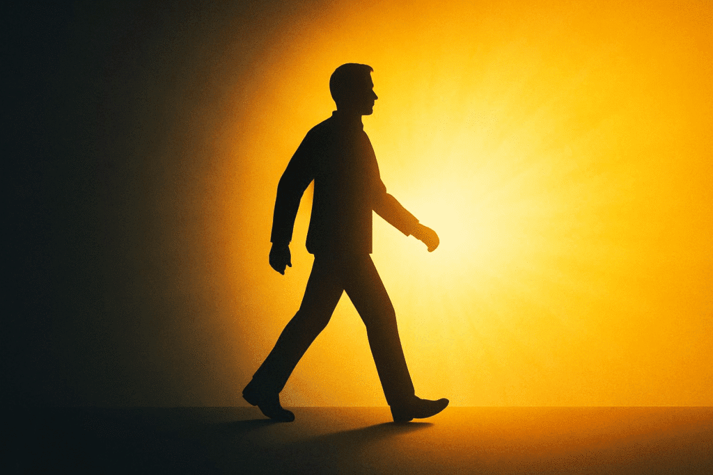 Silhouette of a person walking out of a dark tunnel into bright light, symbolizing the journey from negativity to positivity.